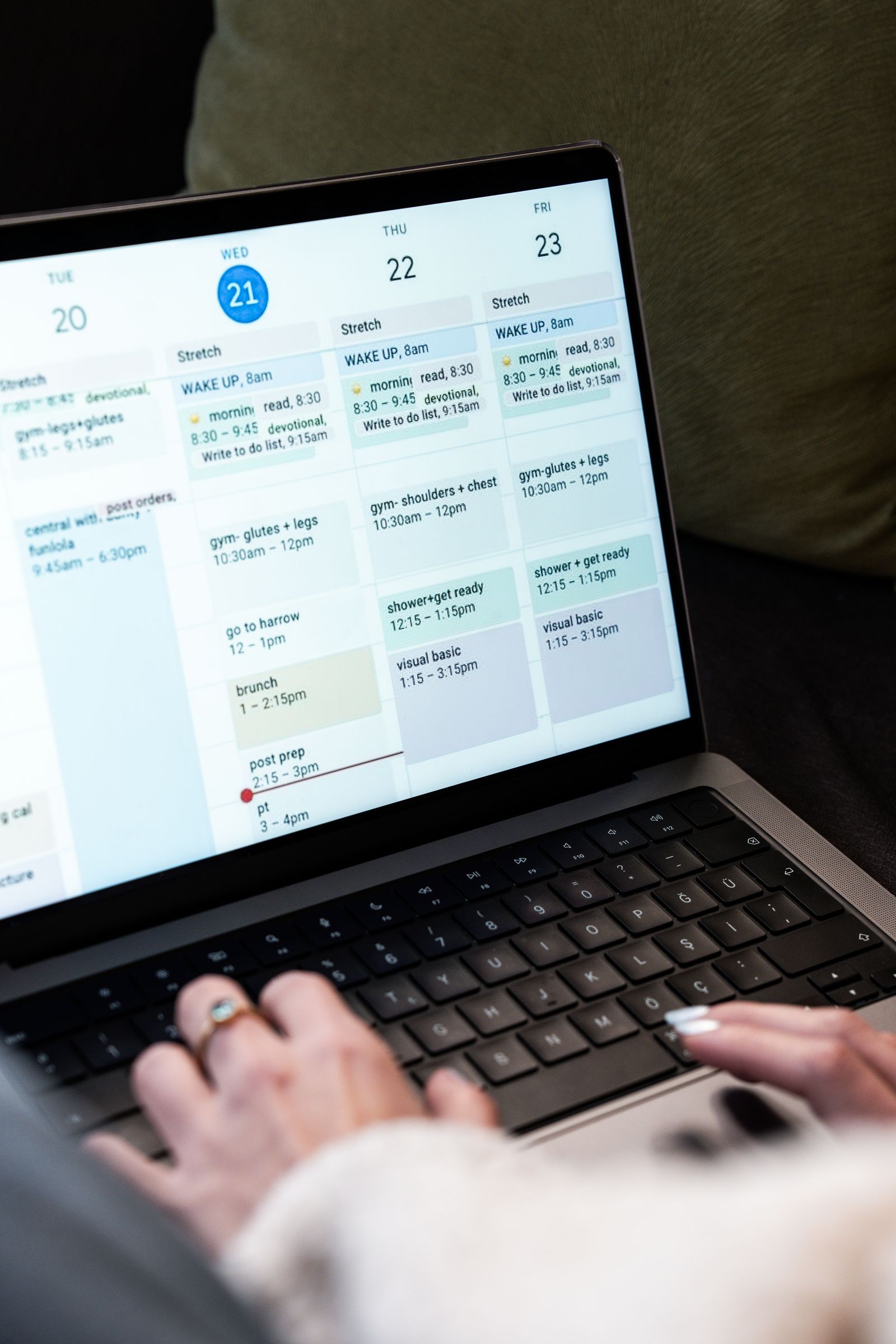 A person using a digital calendar on a laptop.